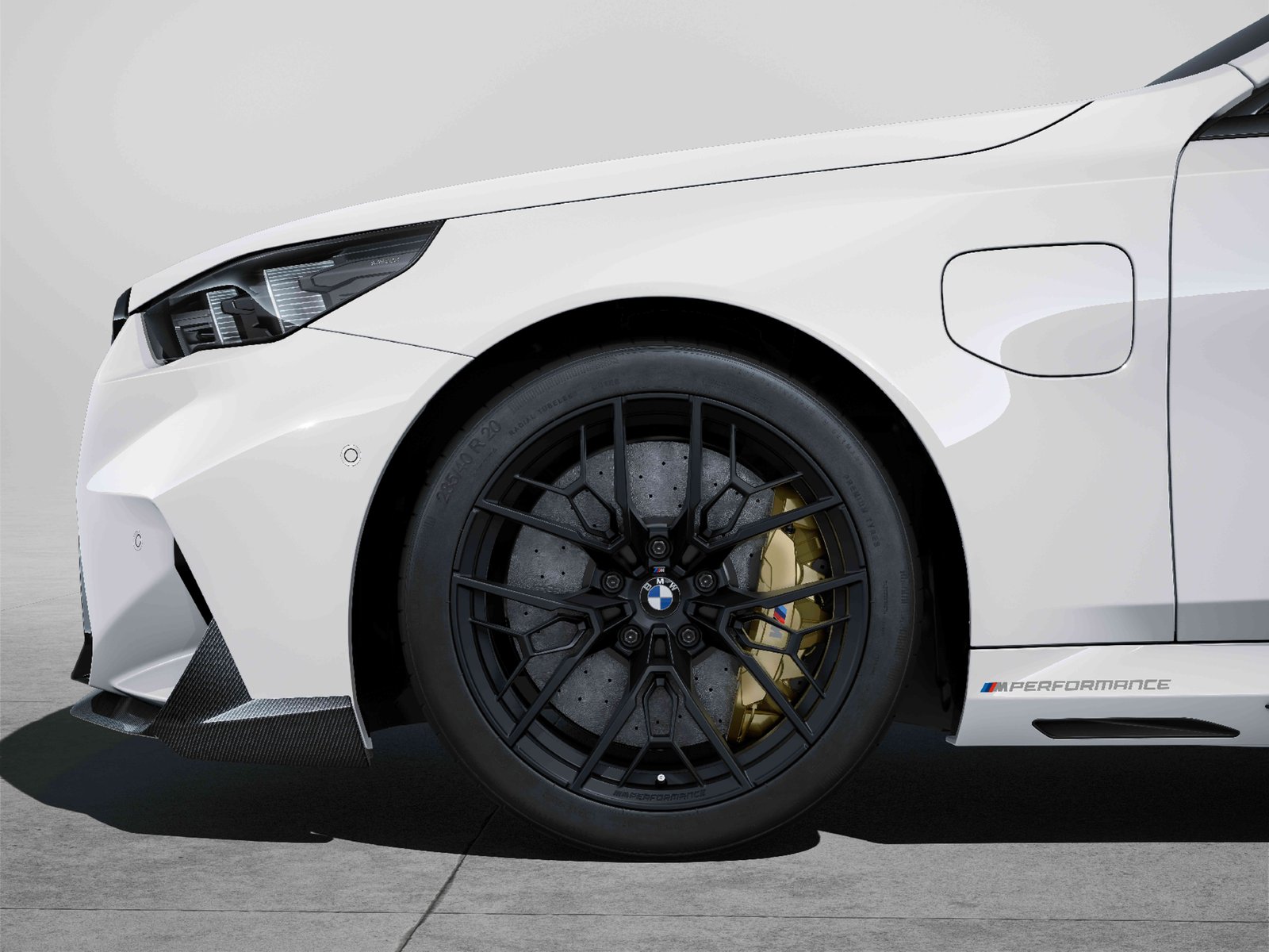 Jet Black high-pressure-cast M Performance wheel on a white BMW M5