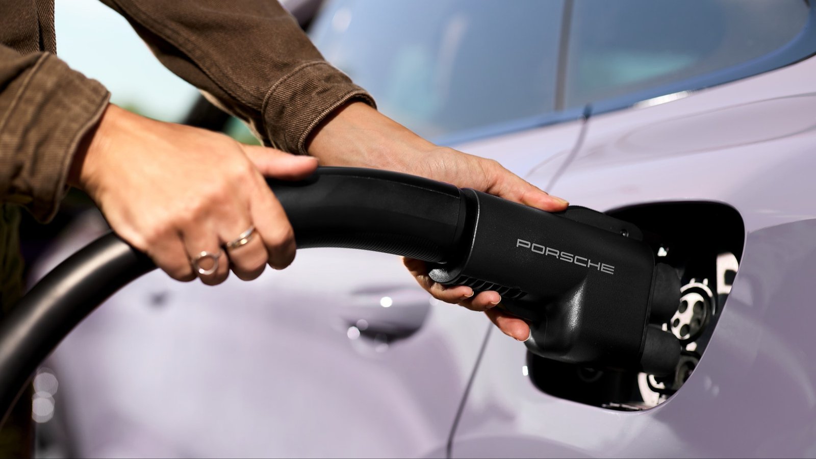 Porsche NACS DC adapter being plugged into a Porsche EV