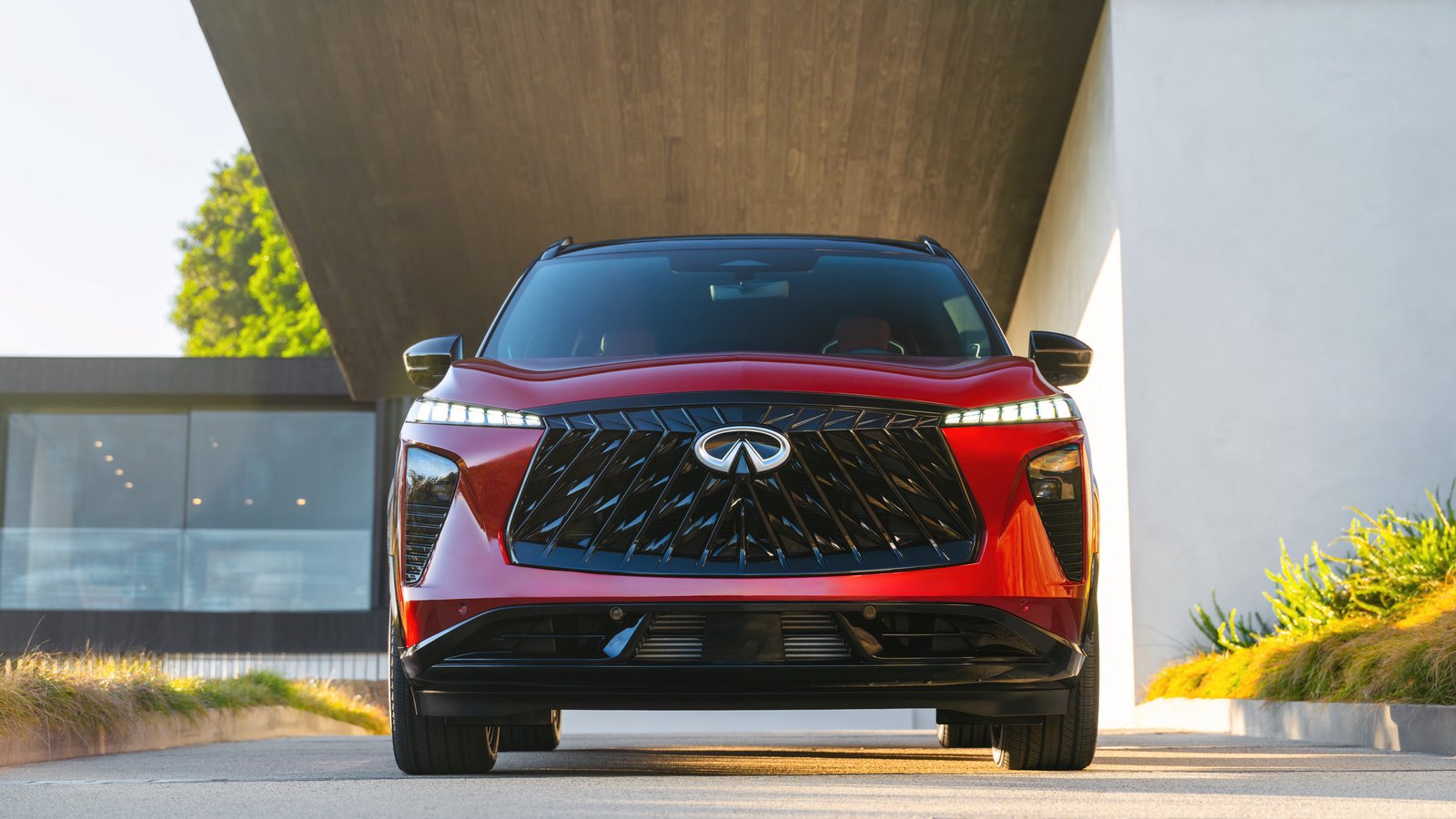 Red 2027 Infiniti QX65 front view with lit piano key daytime running lights