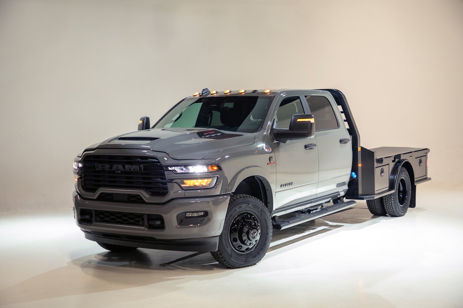 Gray 2027 Ram 3500 Chassis Cab Night Edition with flatbed, studio front three-quarter view