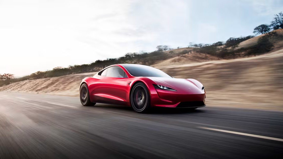Red 2017 Tesla Roadster prototype driving on a rural road