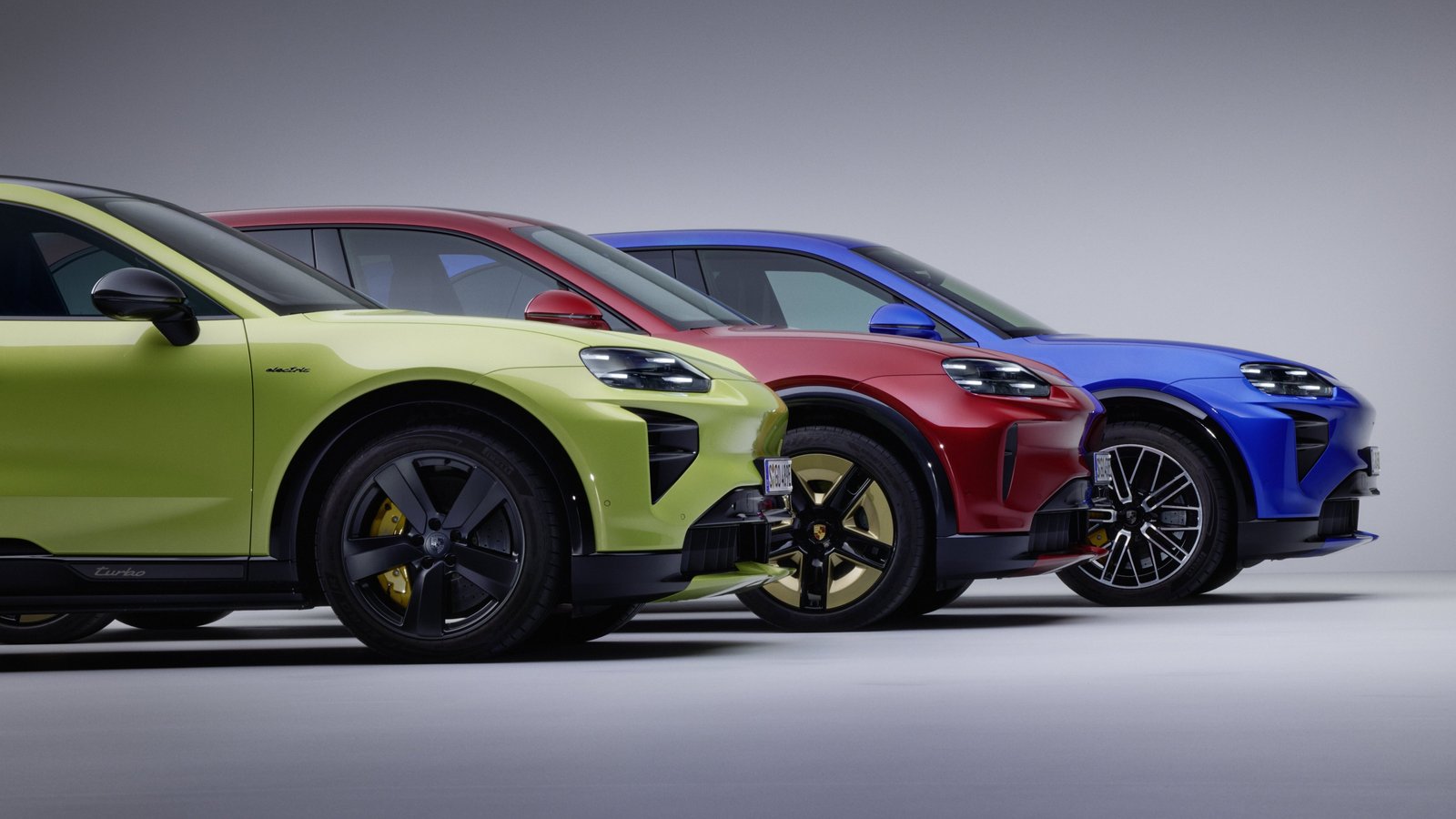 Front view of three 2027 Porsche Cayenne Electric models in bright colors