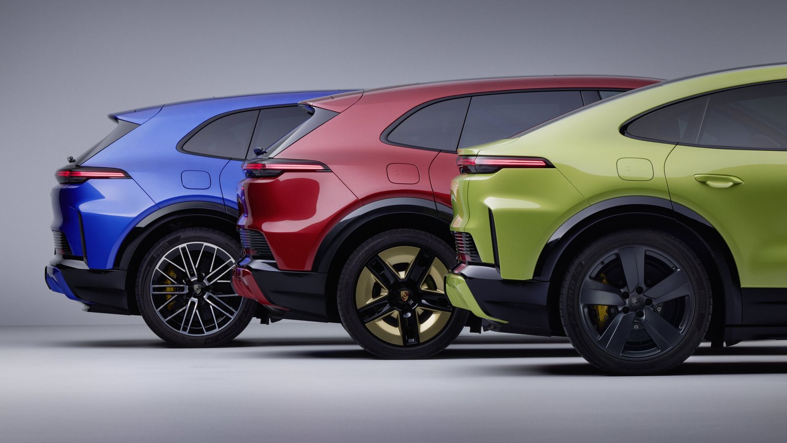 Rear view of 2027 Porsche Cayenne Electric SUVs in three colors
