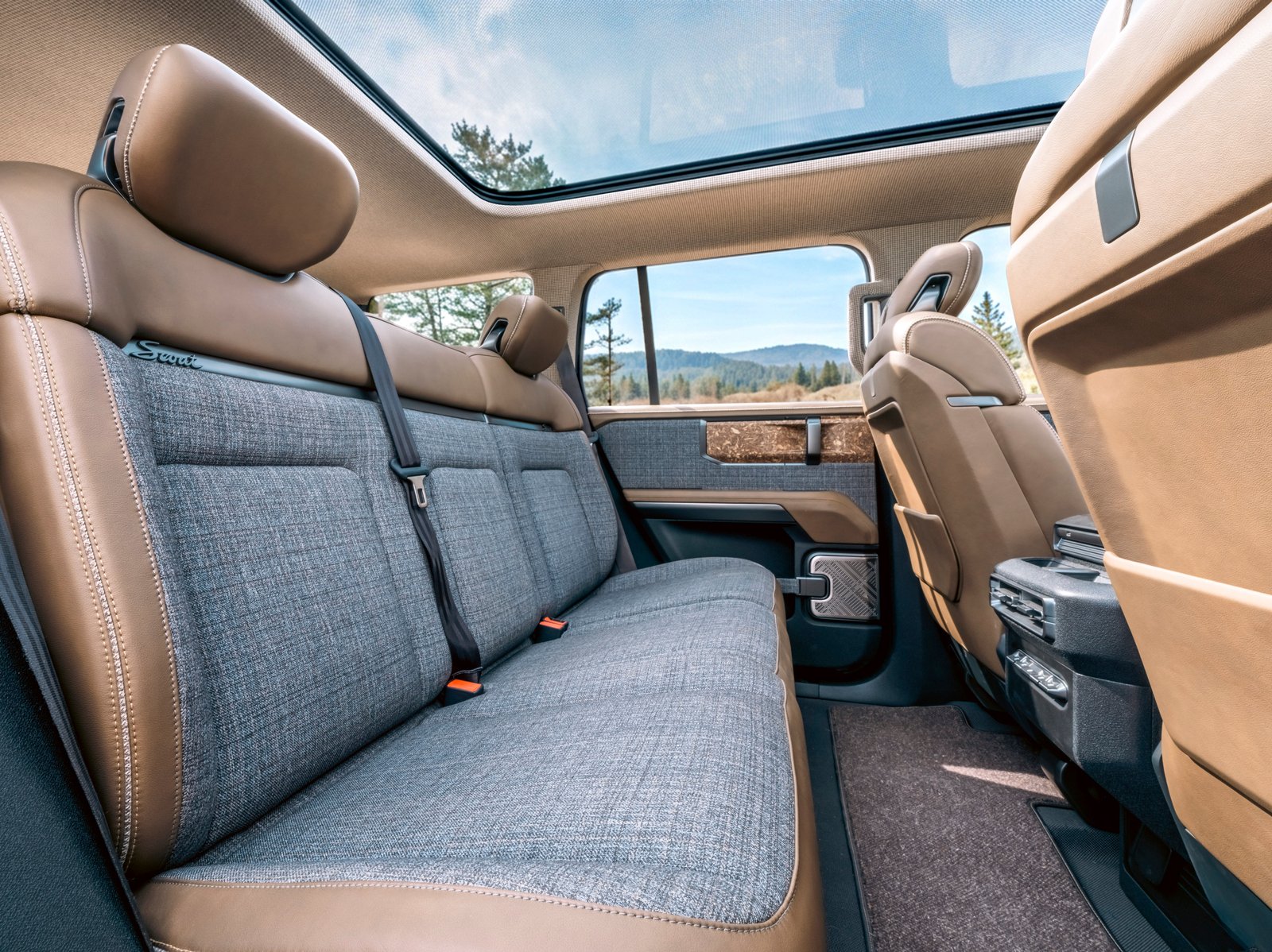 Mountainside concept rear bench with leather, plaid fabric, and walnut trim