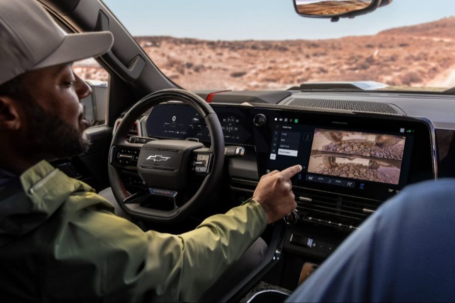Driver using underbody terrain camera views on center screen off-road
