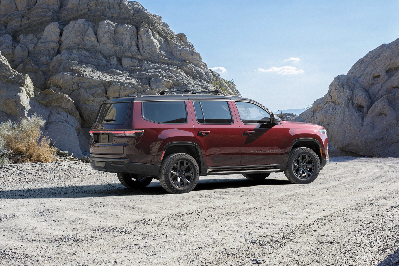 Rear three-quarter view of the 2026 Jeep Grand Wagoneer on a desert road