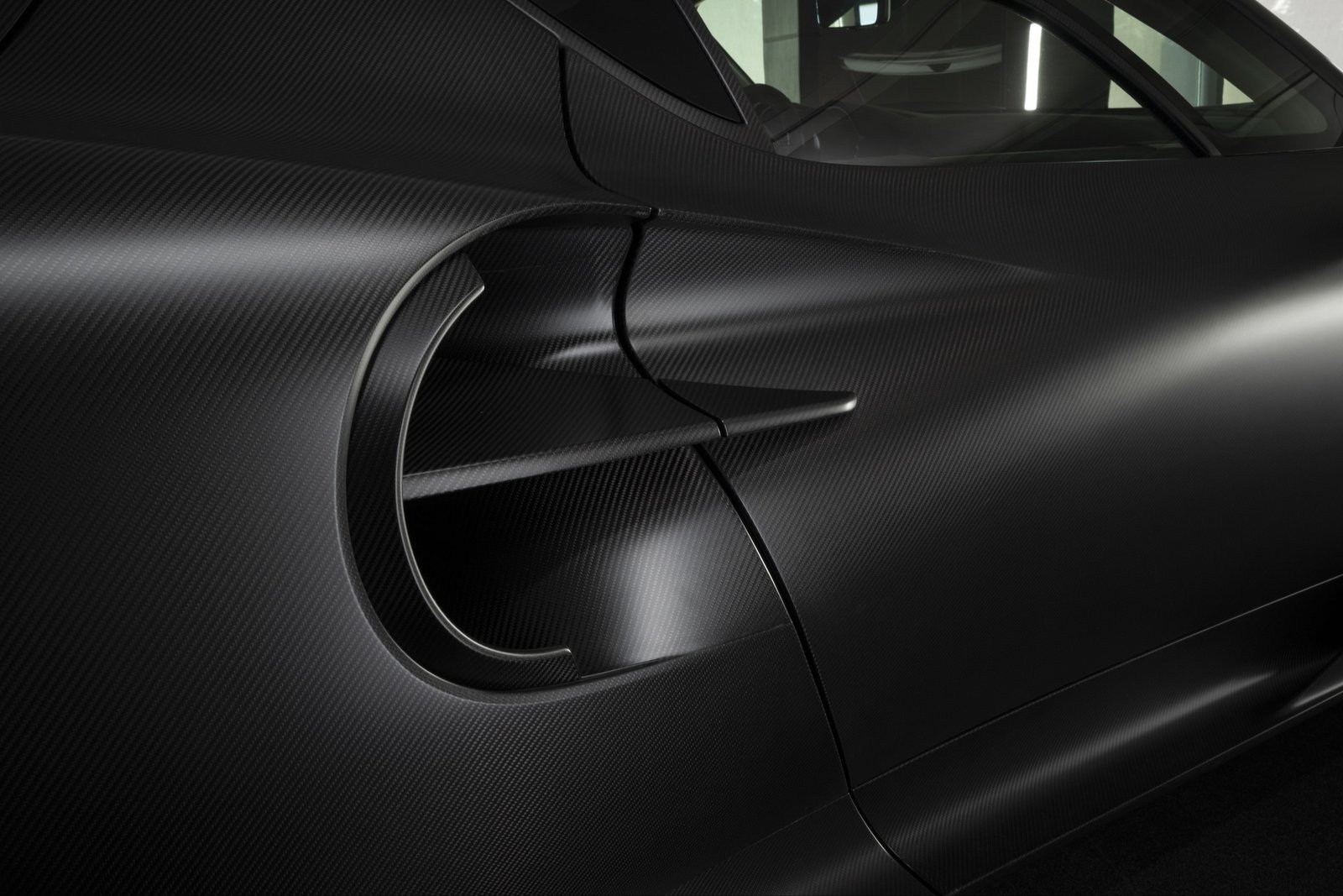 Close-up of the matte carbon-fiber weave on the Alfa Romeo 33 Stradale Perla Nera
