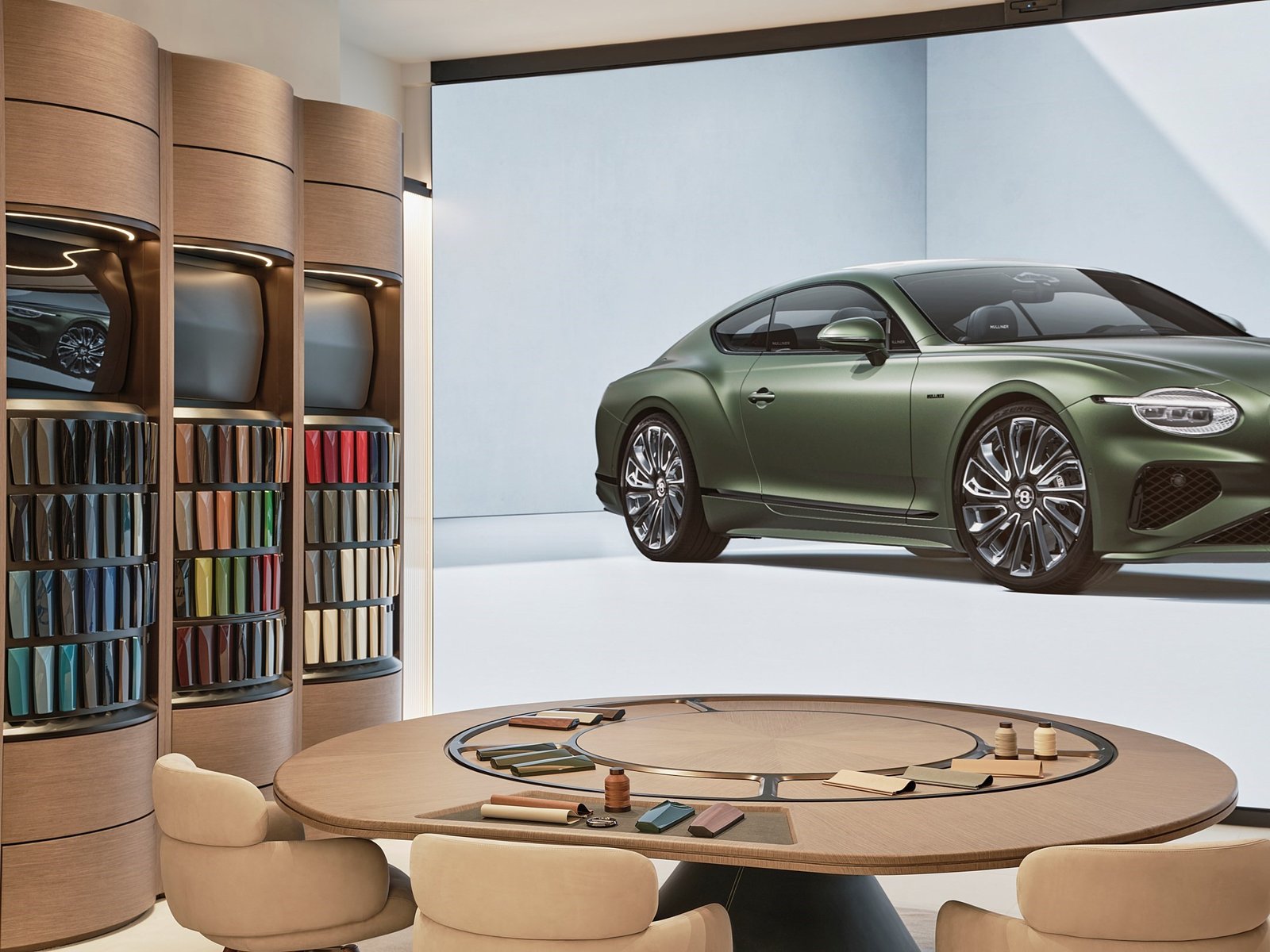 Bentley Atelier with material samples and a Continental GT on an LED wall