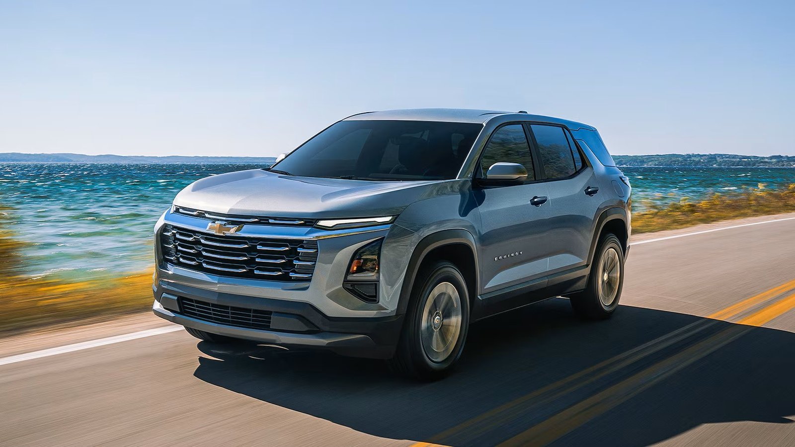 Gray Chevrolet Equinox LT driving along a lakeside road