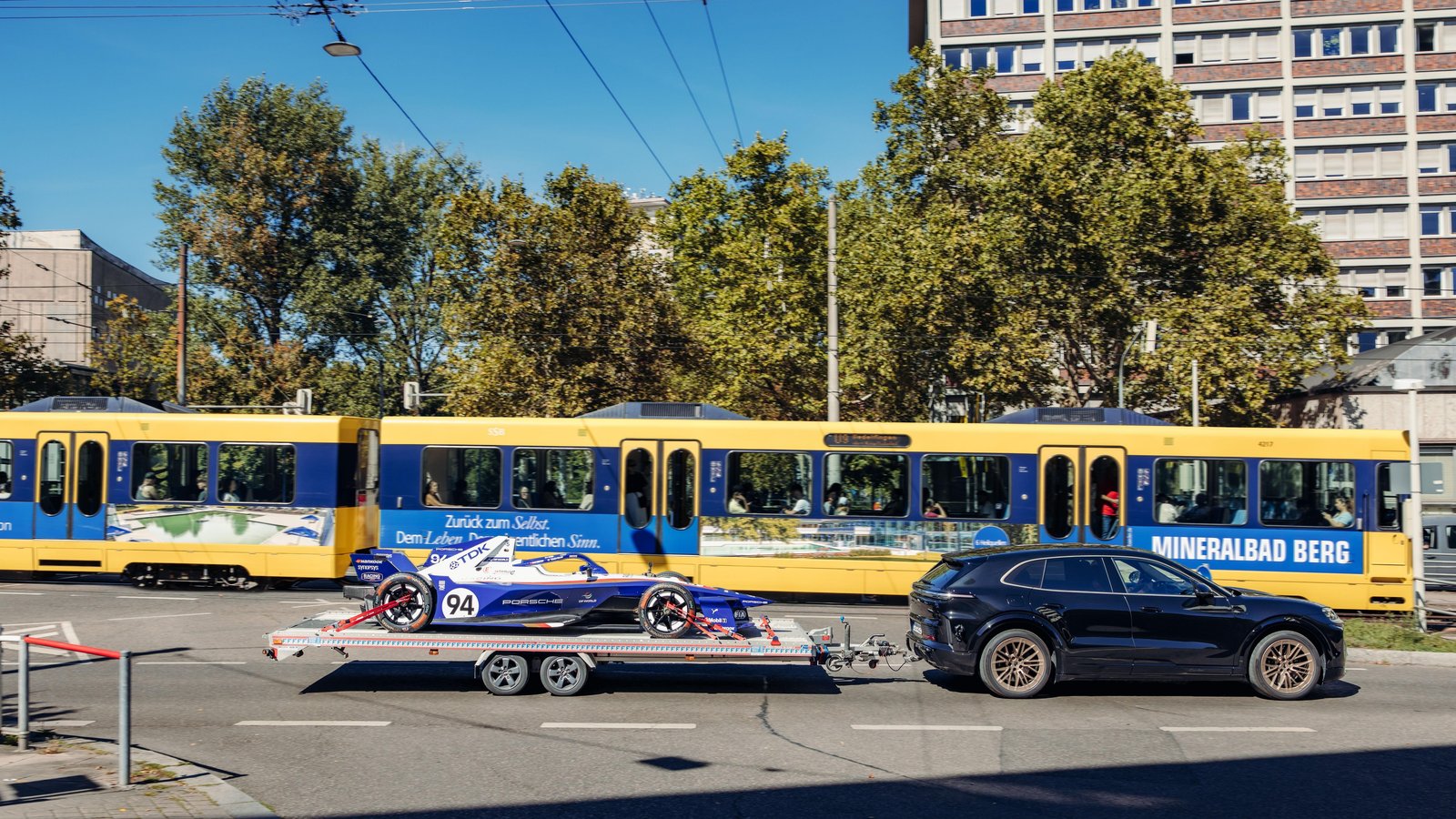 Cayenne Turbo Electric towing the 99X Electric through Stuttgart