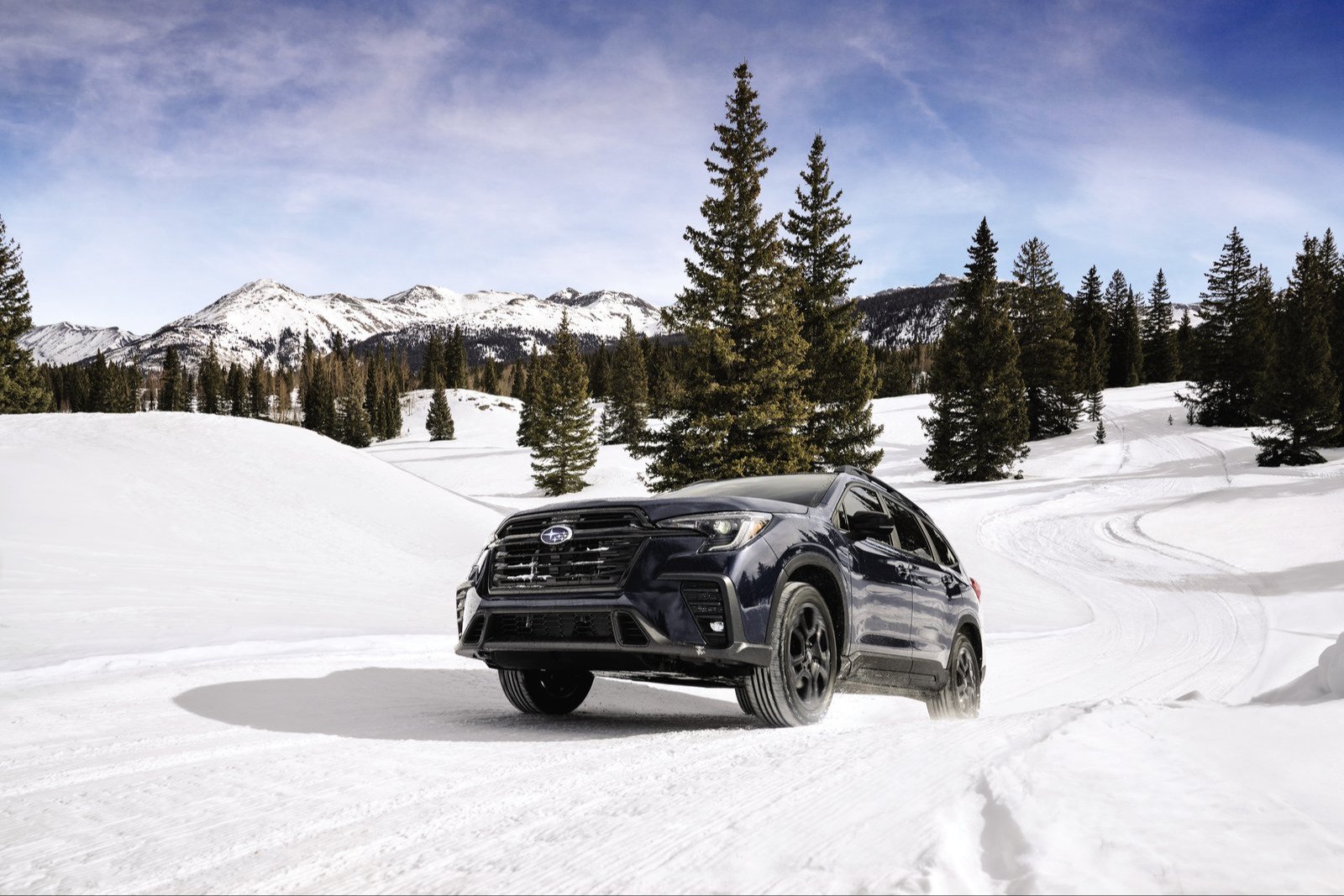Subaru Ascent SUV on a packed-snow trail among pine trees