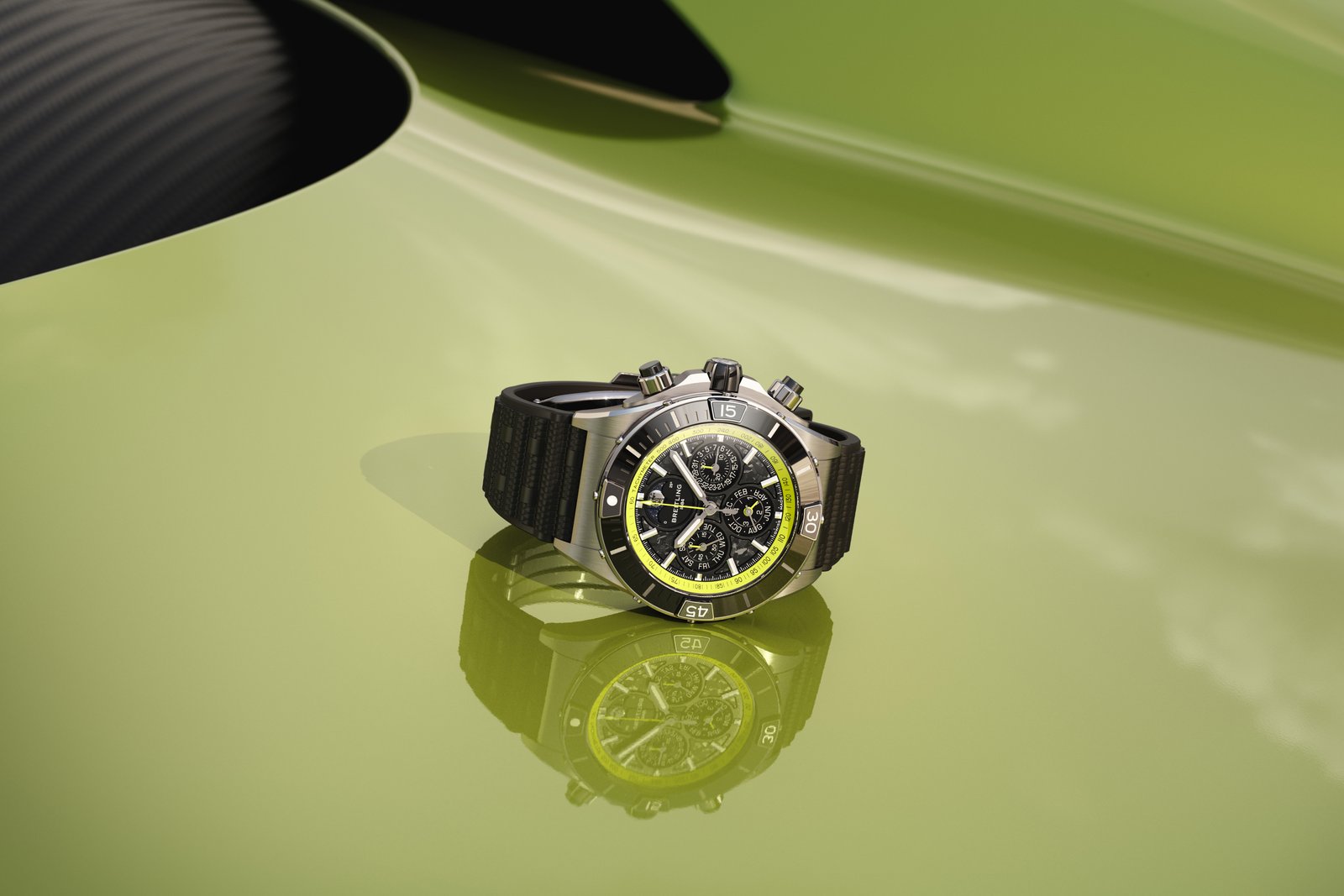 Breitling Super Chronomat B19 44 with lime green rehaut on an Aston Martin Valhalla body panel