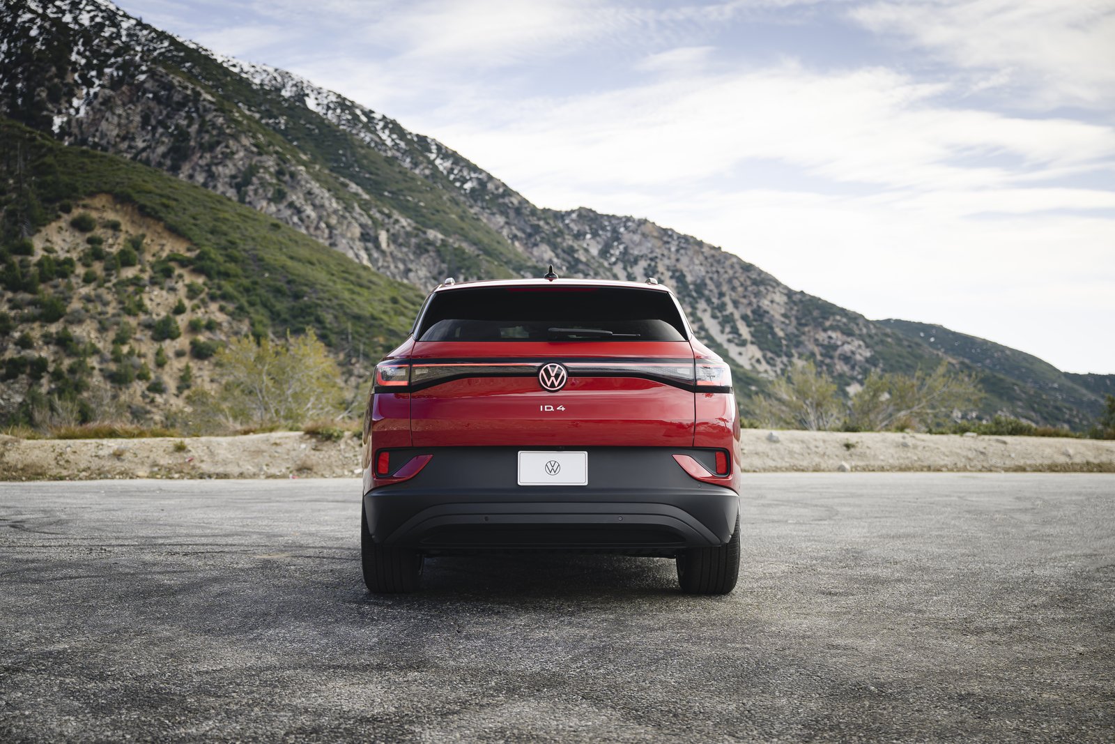 Rear view of a red Volkswagen ID.4 on a mountain road