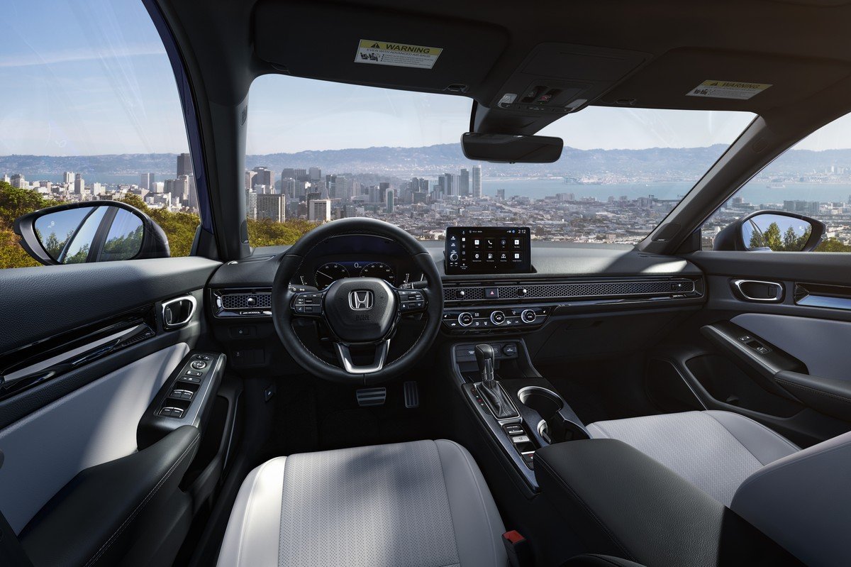 2027 Honda Civic interior with gray front seats and dashboard touchscreen