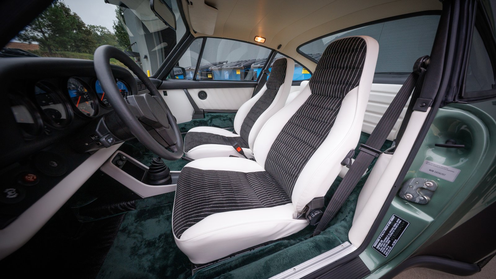 Interior of 1978 Porsche 911 Turbo with white leather seats and pinstripe velour inserts