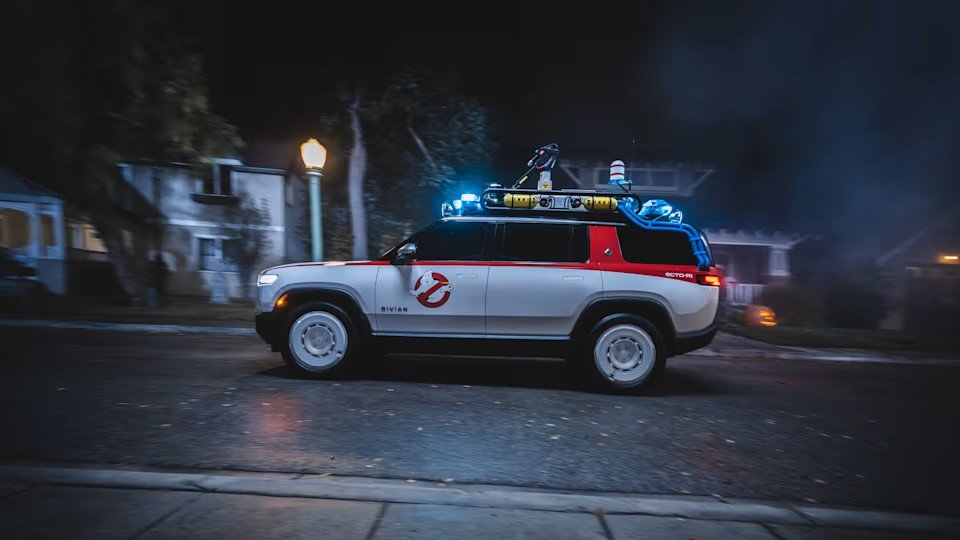 Side view of the Rivian Ecto-R1 with its roof rack and red graphics
