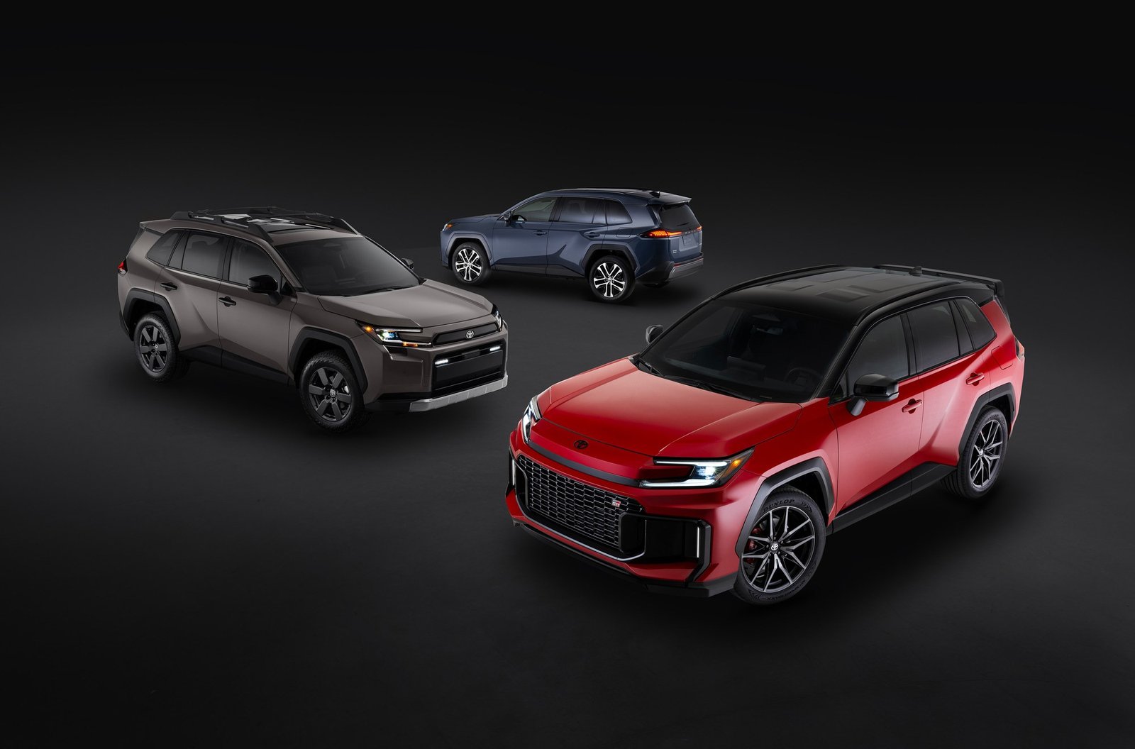 Three versions of the 2026 Toyota RAV4 in a studio