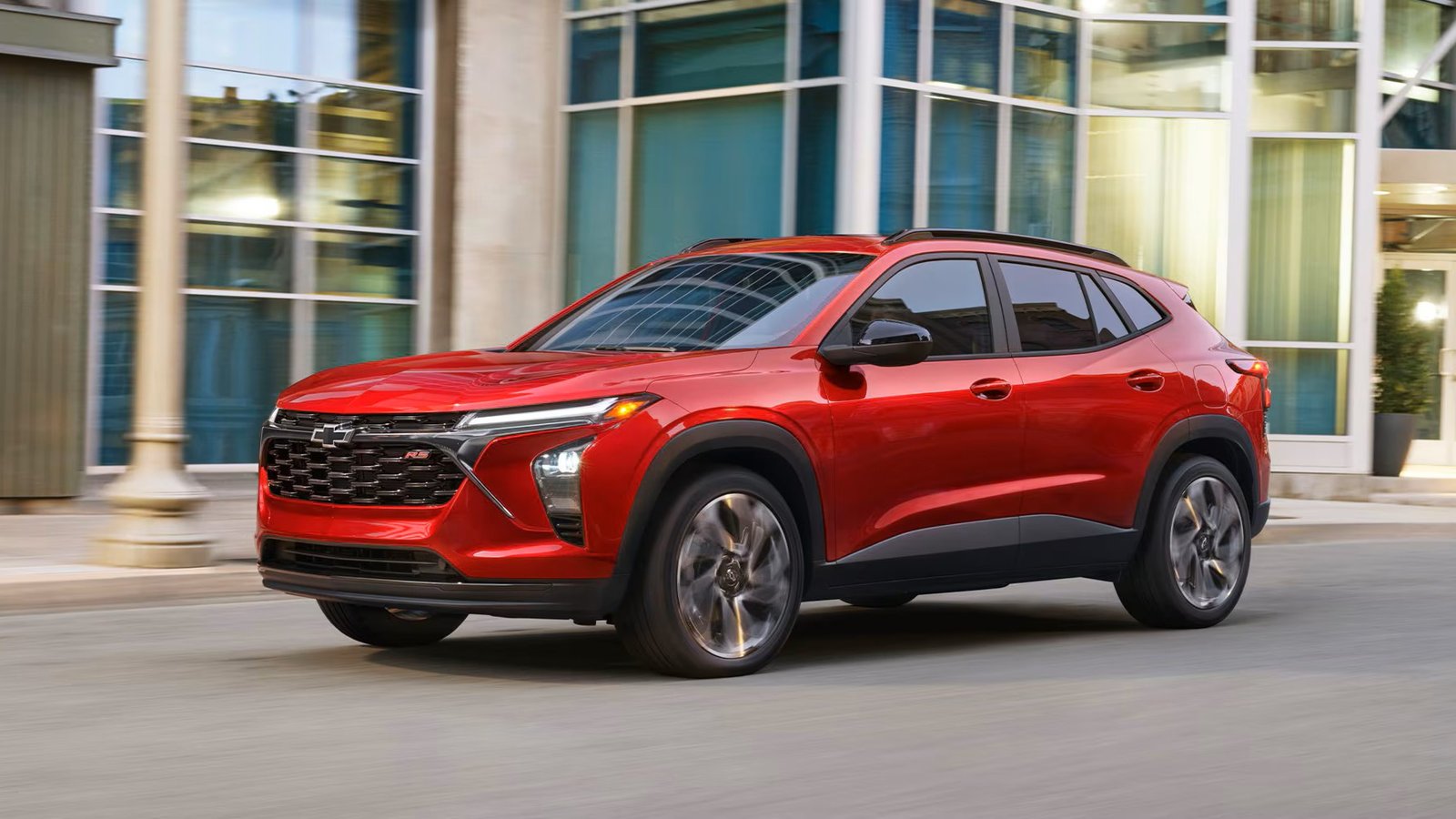Red 2026 Chevrolet Trax RS driving on a city street