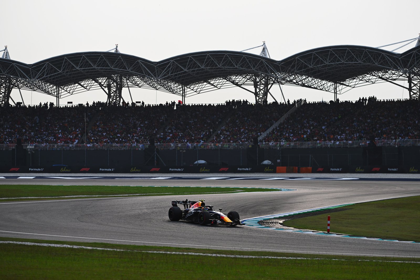 A Red Bull-Ford passes the main grandstand at Sepang International Circuit