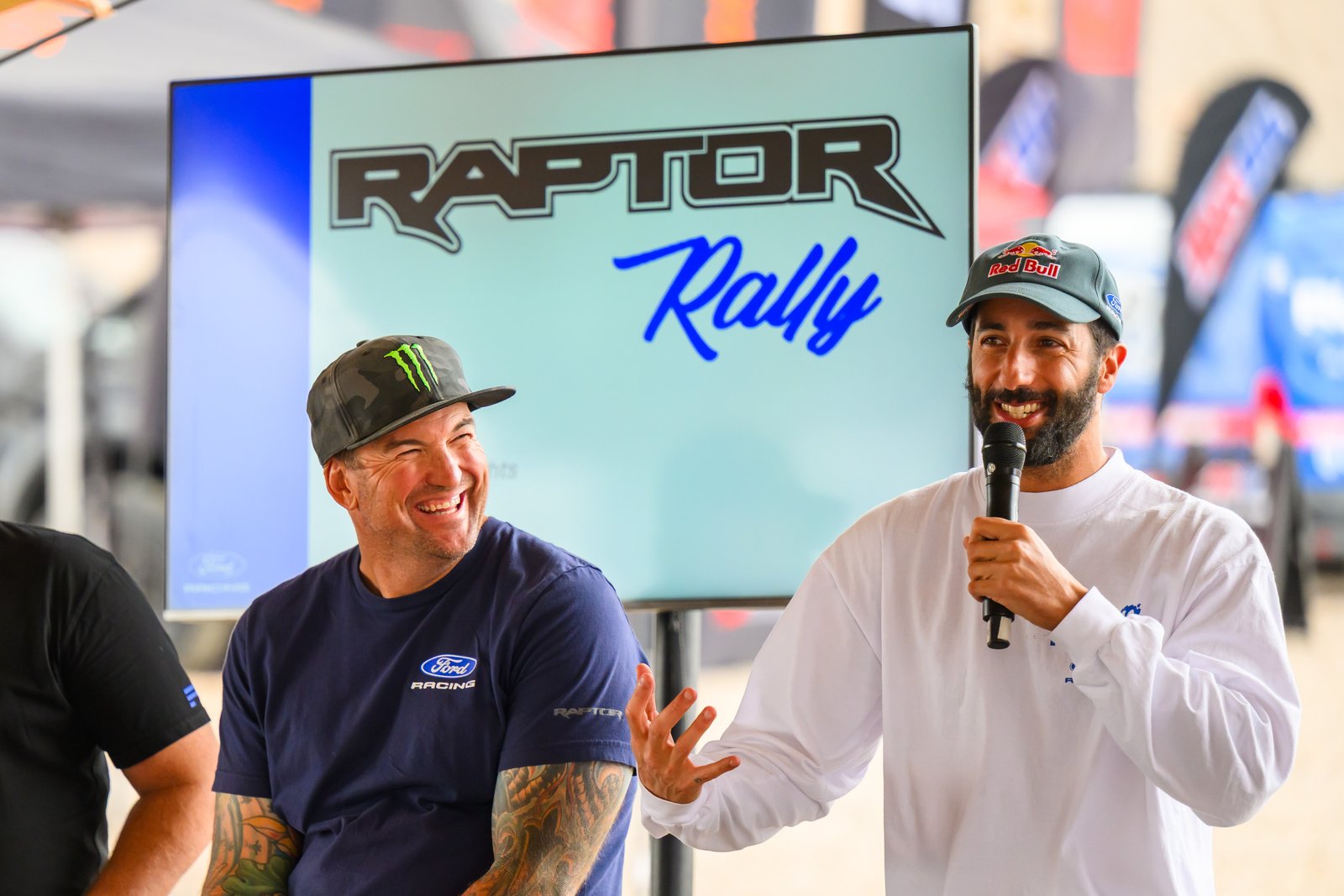 Daniel Ricciardo speaking on stage at Raptor Rally 2026 next to a Ford Racing driver