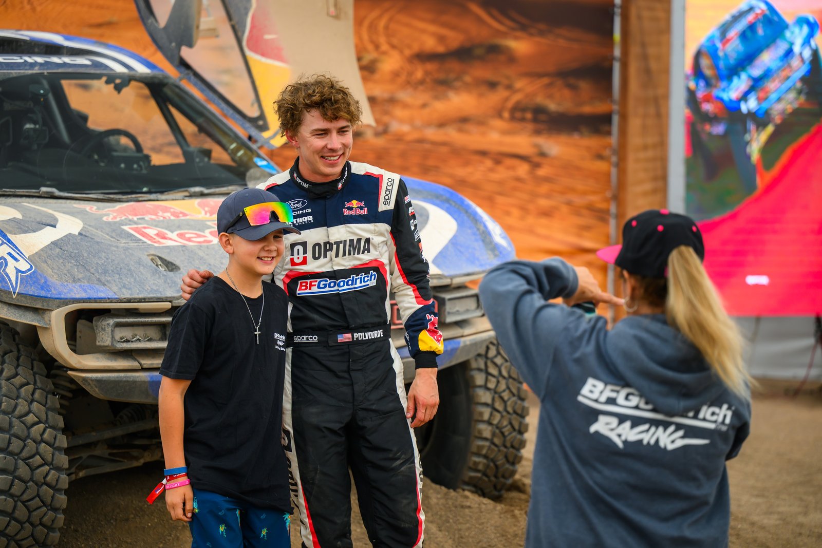 Ford Racing driver Christopher Polvoorde posing with a young fan beside the Raptor T1+