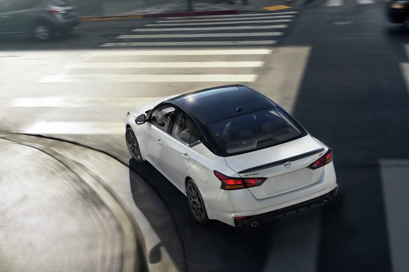 2027 Nissan Altima SR in white with black roof, rear three-quarter view from above