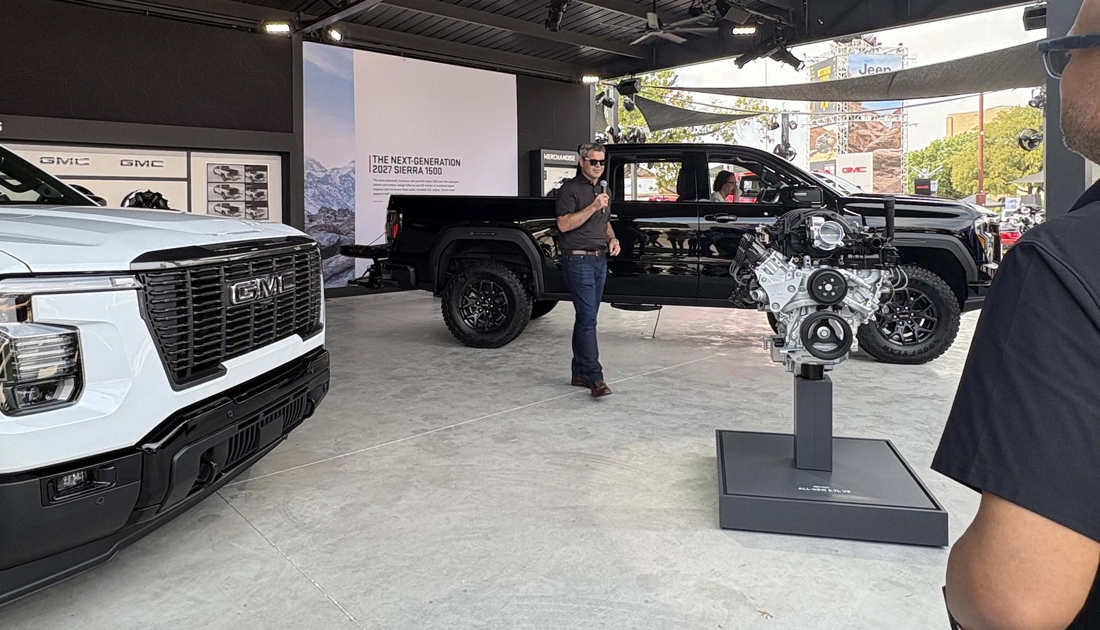 GMC stand with 2027 Sierra trucks and an engine display at the Texas Auto Show