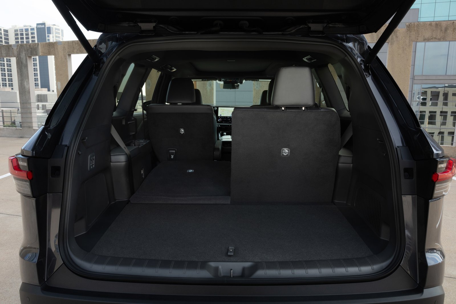 2027 Lexus TX cargo area with third-row seats partly folded