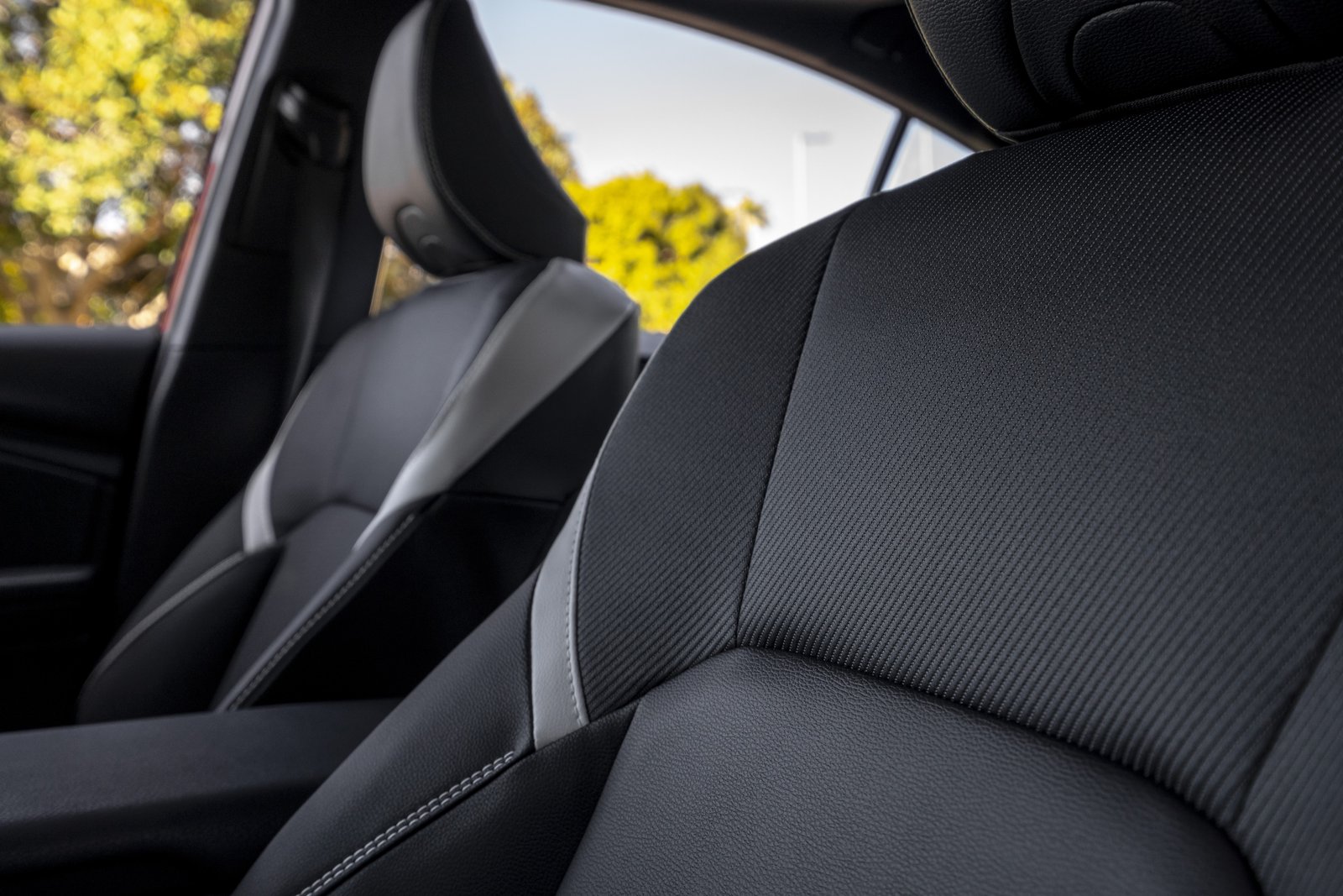 2027 Toyota Camry SE front seats in black SofTex with white accents