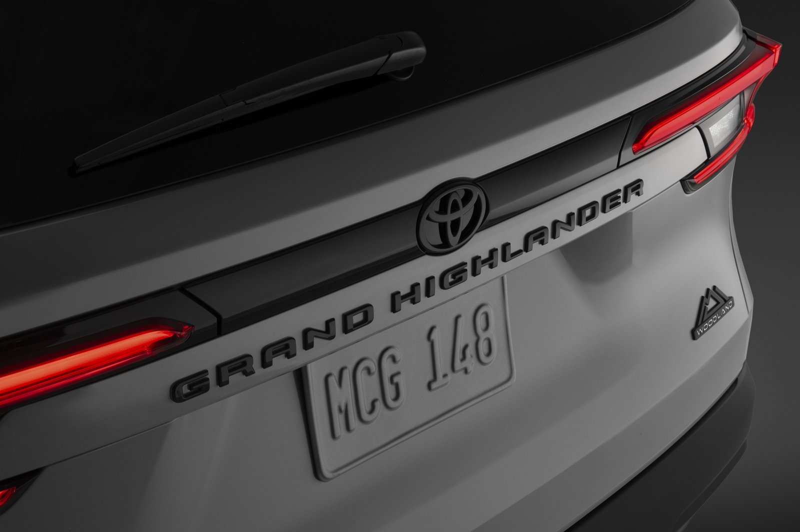 Black Grand Highlander lettering and Woodland badge on the tailgate