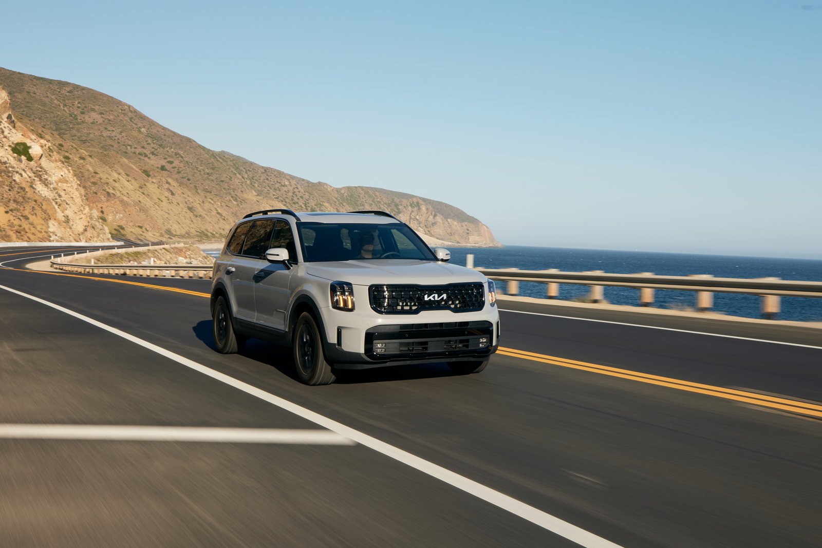2024 Kia Telluride driving on a coastal highway