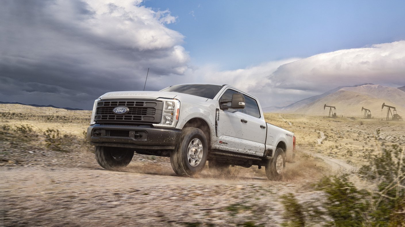 White Ford Super Duty F-250 XL crew cab driving off-road