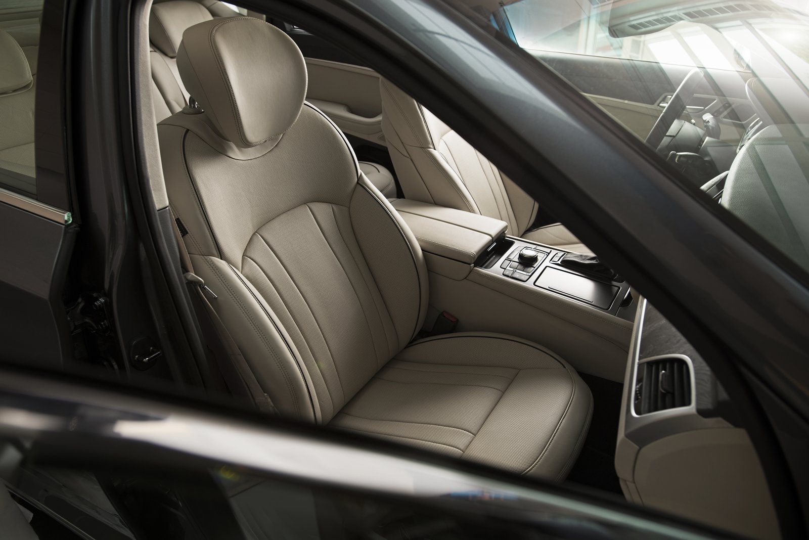 Hyundai Genesis interior showing light leather front seats and center console