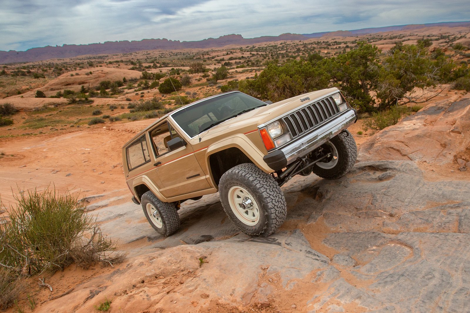 Two-door Jeep Cherokee XJ-based concept crawling over slickrock near Moab