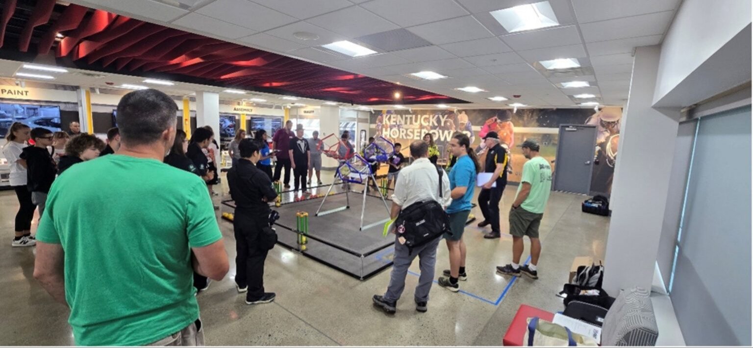 Teams inspect a replica CANOPY competition field inside Toyota Kentucky