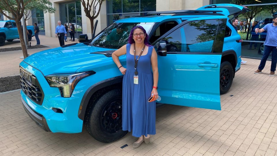 Toyota senior engineer Leeann Sartain beside a blue Sequoia TRD Pro