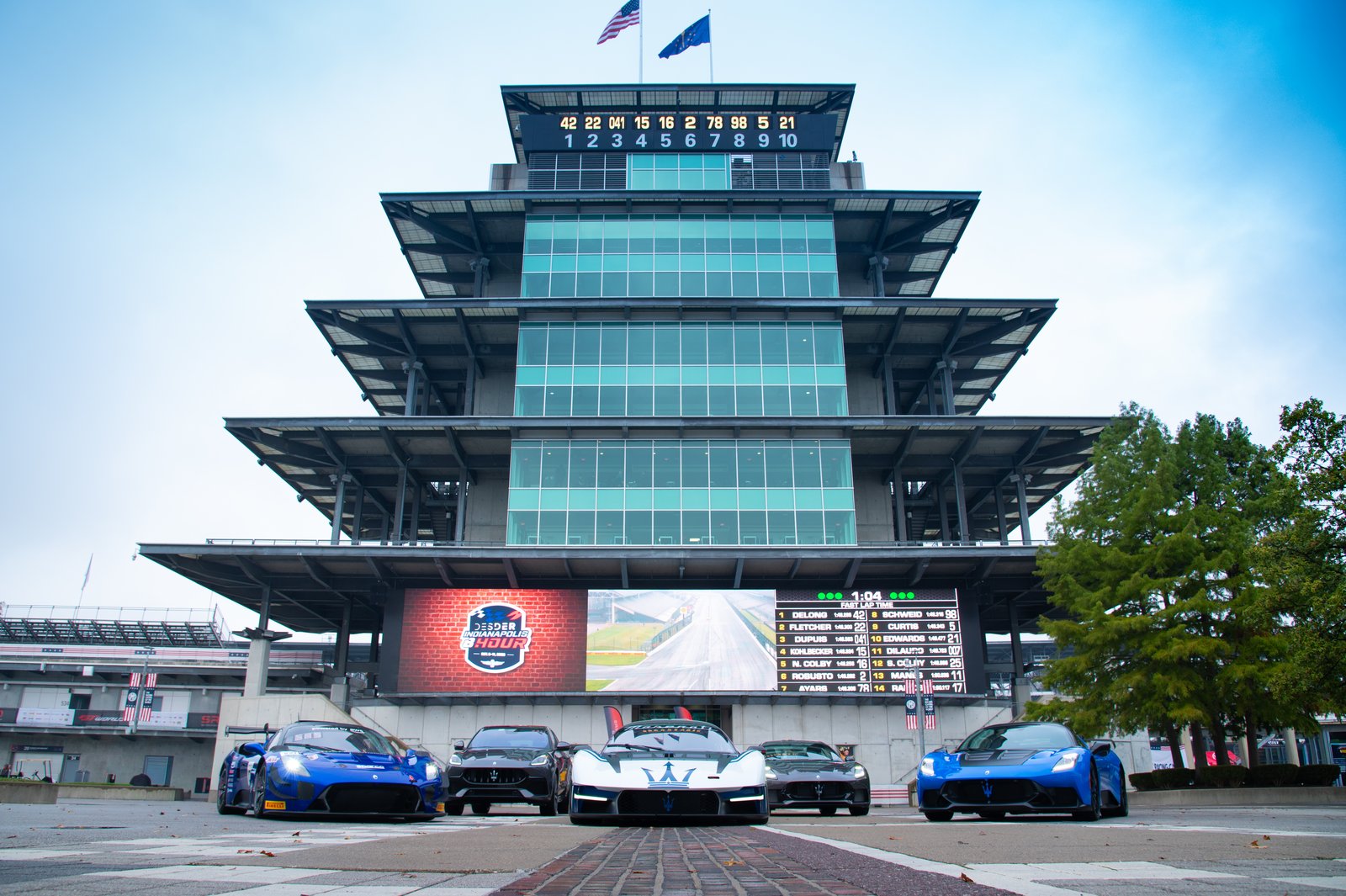 Maserati GT2 lined up with road cars in front of the Indianapolis Pagoda