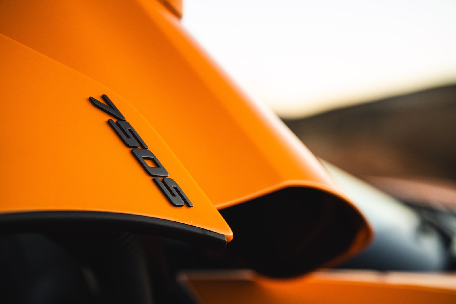 Close-up of the 750S badge on orange McLaren bodywork