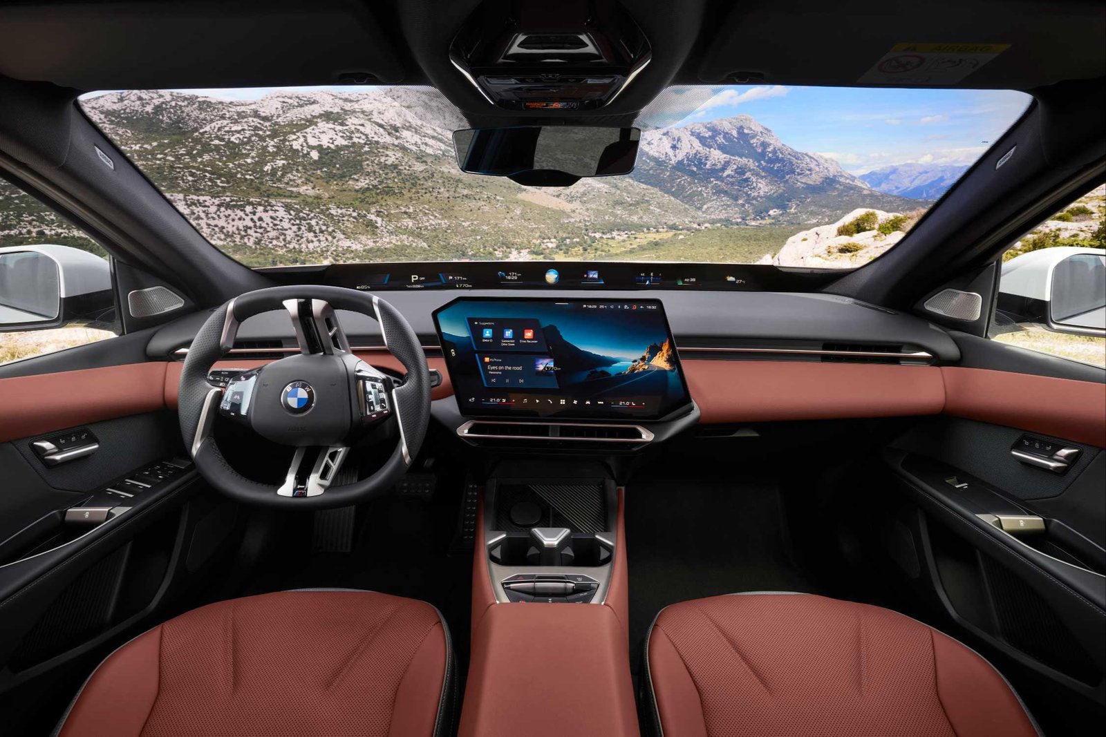 Dashboard of the BMW i3 with central touchscreen and red leather seats