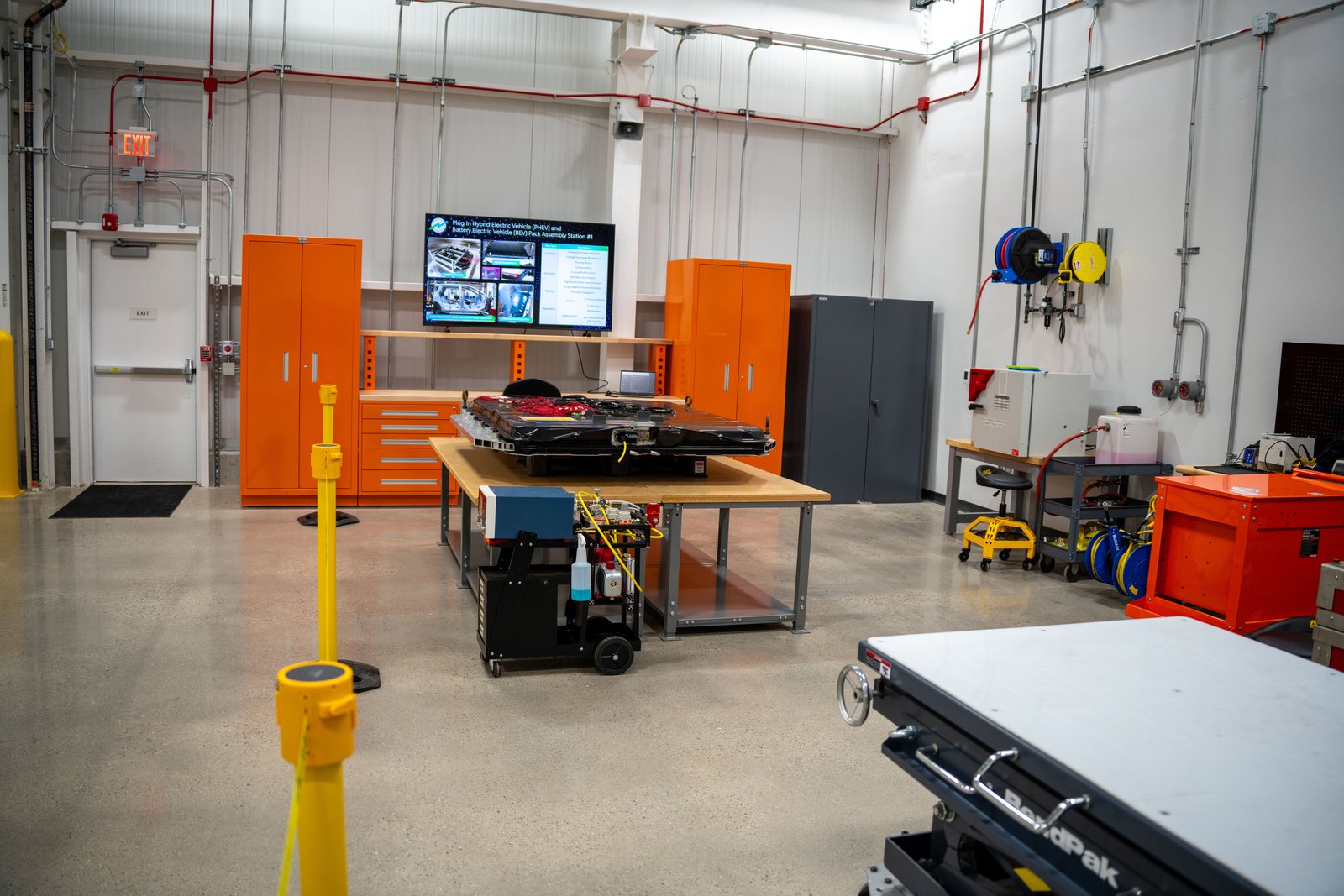 Battery pack preparation area with workbench and tooling at Toyota's Michigan lab