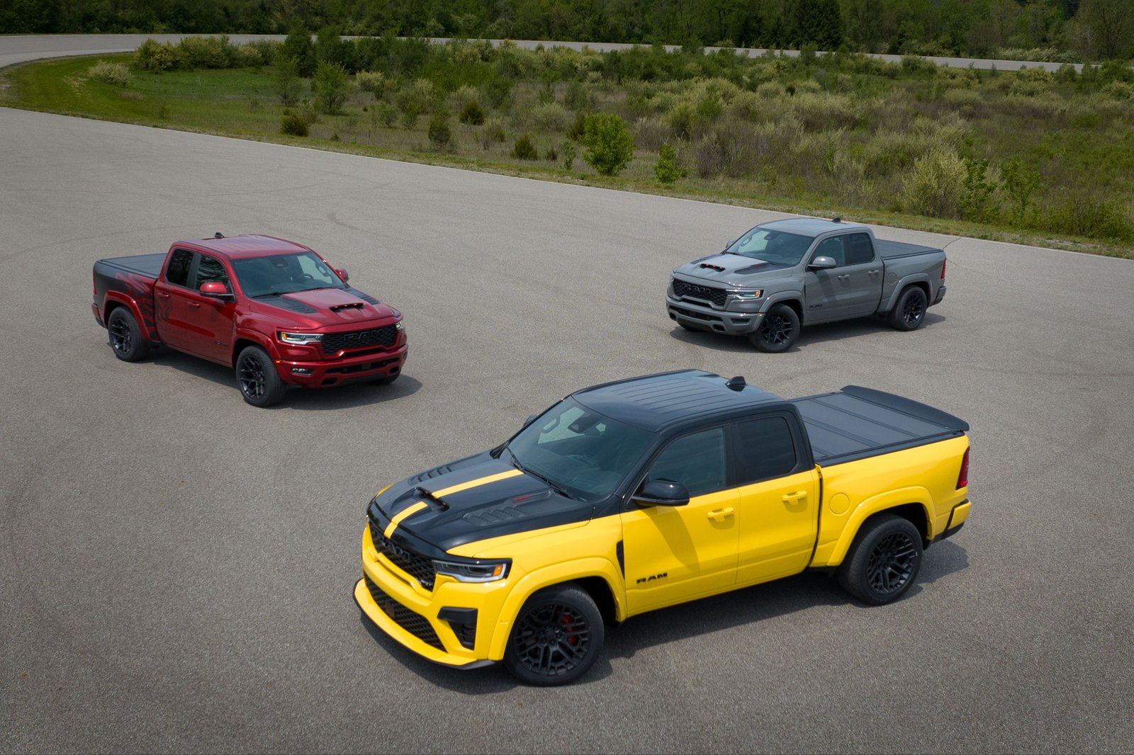 Three 2027 Ram 1500 Rumble Bee muscle trucks on a test track