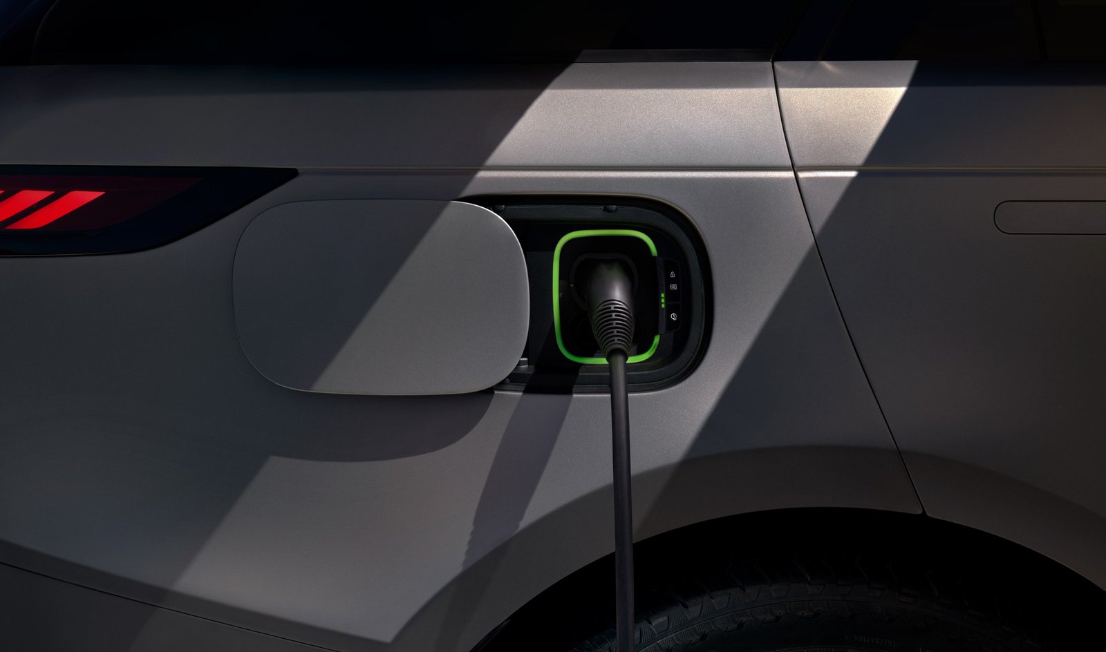 Charging cable plugged into the Range Rover Sport Electric's DC fast-charging port