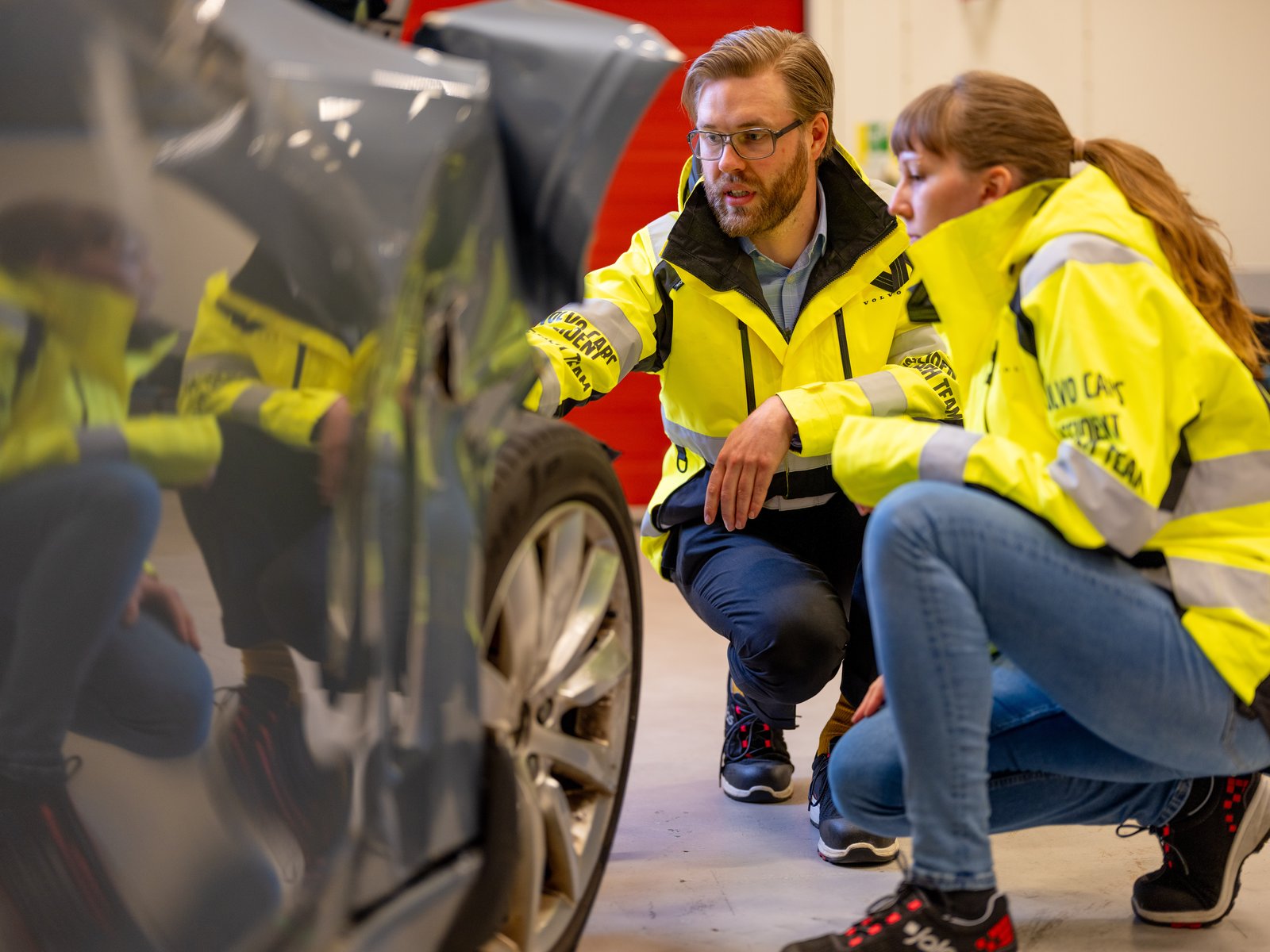 Volvo accident research team members inspect a damaged car
