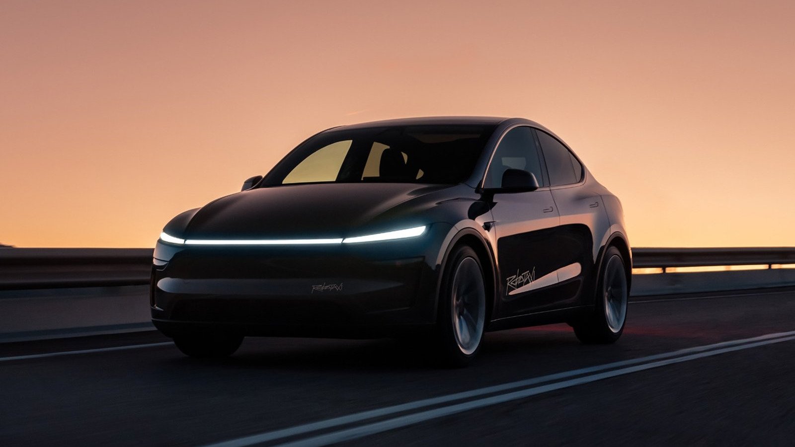 Black Tesla Model Y Robotaxi driving at dusk