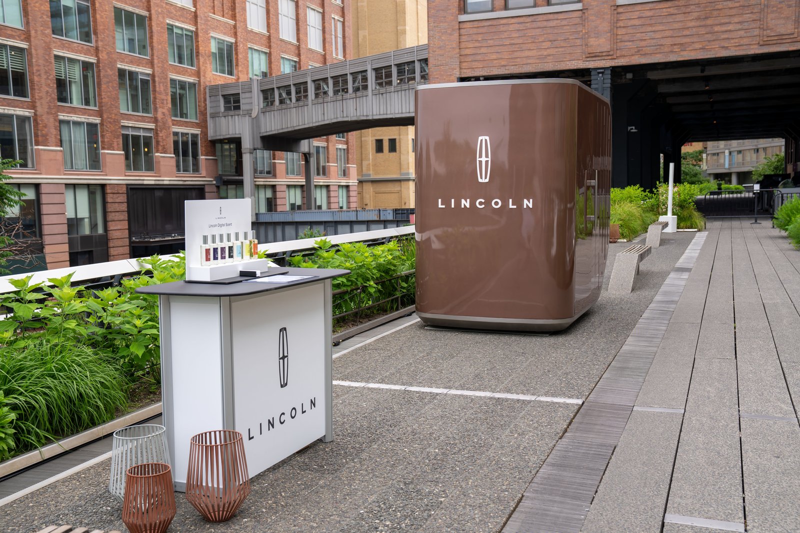 Lincoln Digital Scent bottles on a stand beside the Sanctuary pod