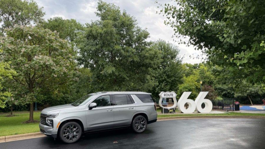 Chevrolet Tahoe parked beside Route 66 letters in a park