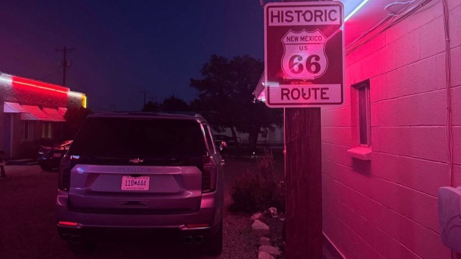 Chevrolet Tahoe at night under neon motel sign on Route 66 in New Mexico