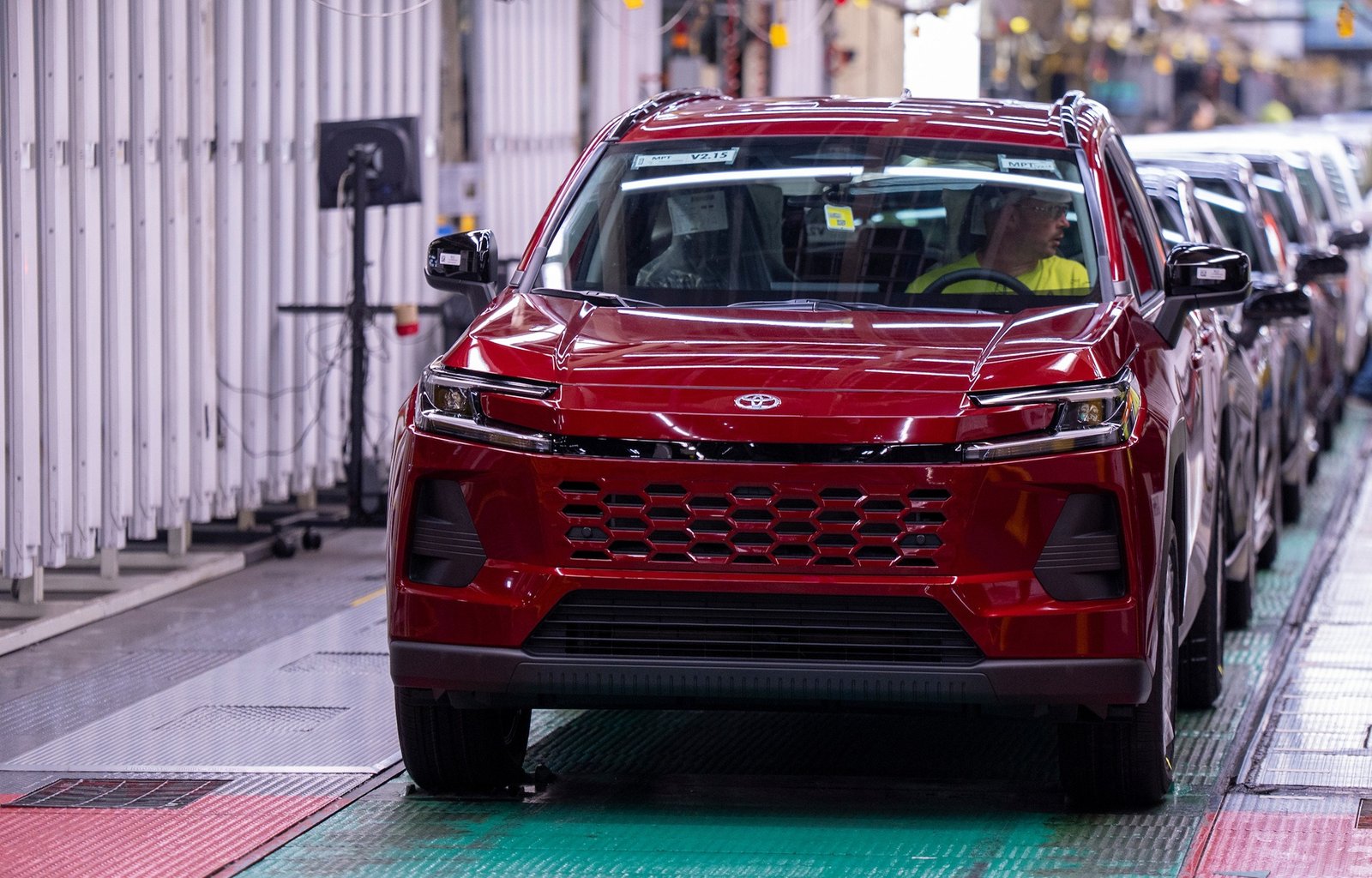 Red Toyota RAV4 rolling along a factory assembly line