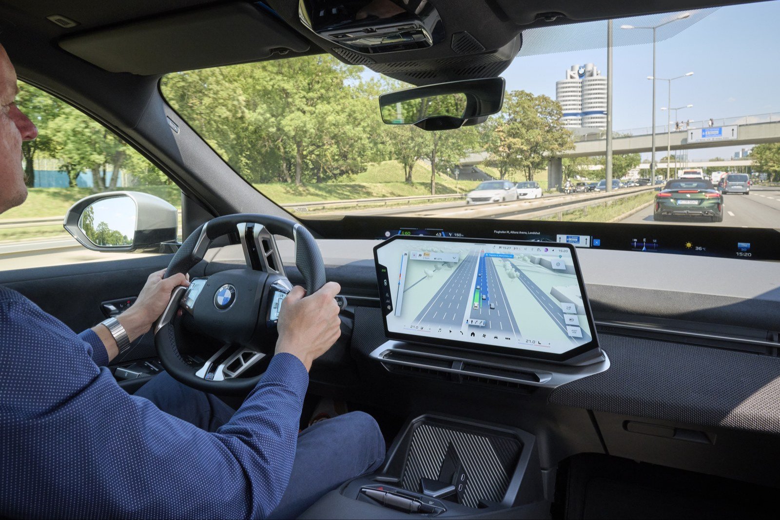 Driver on a Munich highway with BMW Maps 3D view on the center screen