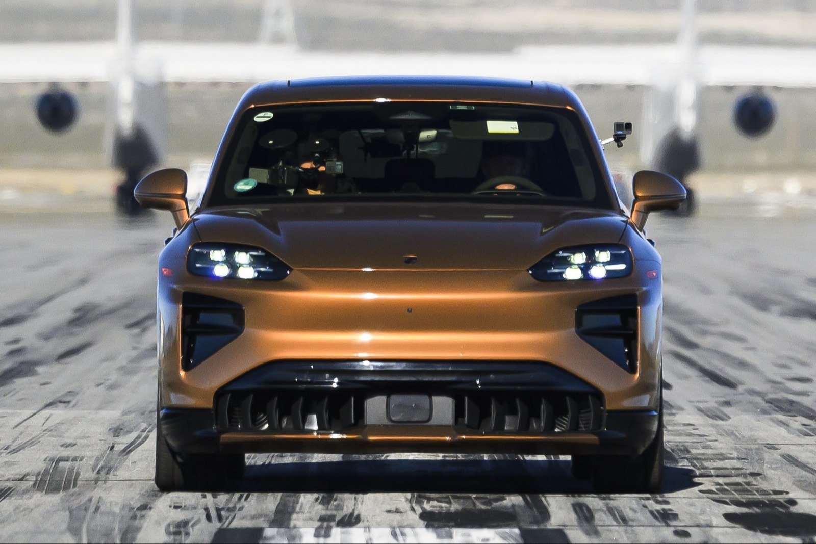 US-spec Porsche Cayenne Turbo Electric driving head-on down a runway